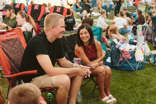 Two people smiling at an outdoor picnic