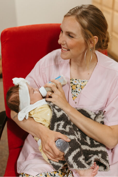 Woman giving a bottle to a baby